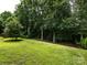 Lush backyard with mature trees and a gently sloping lawn at 12928 Windy Lea Ln, Huntersville, NC 28078