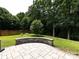Spacious backyard with patio, stone seat, and mature trees offering plenty of privacy at 12928 Windy Lea Ln, Huntersville, NC 28078