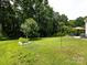 Expansive backyard featuring a large lawn, mature trees, garden, and patio set at 12928 Windy Lea Ln, Huntersville, NC 28078