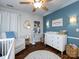Charming Bedroom with wood floors, ceiling fan, changing table, and tasteful decorations creates a warm and inviting space at 12928 Windy Lea Ln, Huntersville, NC 28078