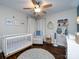Charming Bedroom with a white crib, cozy chair, and playful decor creating a warm and inviting space at 12928 Windy Lea Ln, Huntersville, NC 28078