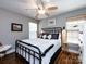 Cozy bedroom featuring hardwood floors, a ceiling fan, and natural light creating a comfortable retreat at 12928 Windy Lea Ln, Huntersville, NC 28078