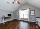 Spacious bonus room with vaulted ceilings, natural light, and hardwood floors, perfect for a home office or entertainment area at 12928 Windy Lea Ln, Huntersville, NC 28078