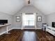 Bright bonus room with vaulted ceilings, hardwood floors, and ample space for various activities at 12928 Windy Lea Ln, Huntersville, NC 28078