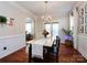 Bright dining room featuring a chandelier, wood floors, and an archway to another room at 12928 Windy Lea Ln, Huntersville, NC 28078