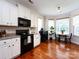 Bright kitchen featuring stainless steel appliances, and adjacent breakfast nook with bay window at 12928 Windy Lea Ln, Huntersville, NC 28078