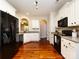 Kitchen with white cabinets, granite countertops, stainless steel appliances, and hardwood floors at 12928 Windy Lea Ln, Huntersville, NC 28078