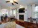 Bright living room featuring a fireplace, hardwood floors, and an open layout for entertaining at 12928 Windy Lea Ln, Huntersville, NC 28078