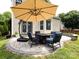 Spacious stone patio with comfortable seating and an umbrella, perfect for outdoor relaxation and entertaining at 12928 Windy Lea Ln, Huntersville, NC 28078