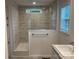 Bathroom featuring a tiled shower with glass door and a framed window at 130 Zircon Dr, Statesville, NC 28625