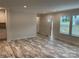 Open living room with neutral paint, wood-look floors, and plenty of natural light at 130 Zircon Dr, Statesville, NC 28625