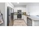 Well-lit kitchen features stainless steel appliances, granite counters, and wood-look flooring at 1315 East Blvd, Charlotte, NC 28203