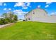 Spacious backyard with lush green grass, privacy fence, and white siding home at 132 Sycamore Crossing Ct, Locust, NC 28097