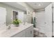 Well-lit bathroom featuring a double vanity and shower with modern fixtures and decor at 132 Sycamore Crossing Ct, Locust, NC 28097