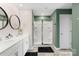 Modern bathroom boasting a double vanity with sleek sinks and a spacious glass-enclosed shower at 132 Sycamore Crossing Ct, Locust, NC 28097