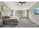 Spacious primary bedroom featuring carpeted floors, ceiling fan, and a decorative dresser at 132 Sycamore Crossing Ct, Locust, NC 28097