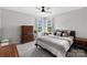 Cozy bedroom with carpet, ceiling fan, many pillows, and natural light from the window at 132 Sycamore Crossing Ct, Locust, NC 28097