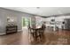 Bright and airy dining area that features hardwood floors, a modern light fixture and sliding door access to yard at 132 Sycamore Crossing Ct, Locust, NC 28097