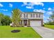 Charming two-story home with a well-manicured lawn, stone accents, and a two-car garage at 132 Sycamore Crossing Ct, Locust, NC 28097