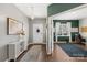 Inviting foyer featuring wood floors, a console table, and seamless flow into the dining room and office space at 132 Sycamore Crossing Ct, Locust, NC 28097
