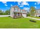 Beautiful two-story home with stone accents, manicured lawn, and mature trees at 132 Sycamore Crossing Ct, Locust, NC 28097