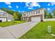 A charming two-story home with a lush green lawn and a two car garage at 132 Sycamore Crossing Ct, Locust, NC 28097