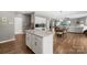 Open kitchen with granite countertops, stainless appliances and an island, flowing into the dining and living spaces at 132 Sycamore Crossing Ct, Locust, NC 28097