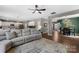 Spacious living room featuring a large sectional couch and open floor plan to kitchen and dining areas at 132 Sycamore Crossing Ct, Locust, NC 28097