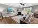 Comfortable living room with fireplace and a large TV screen, designed for relaxation and entertainment, with hardwood floors at 132 Sycamore Crossing Ct, Locust, NC 28097
