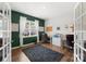 Dedicated home office space with ample natural light, perfect for remote work or study, featuring hardwood floors at 132 Sycamore Crossing Ct, Locust, NC 28097