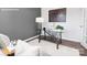 Bright office features a modern glass desk, light grey walls, and a periodic table of elements artwork at 1386 6Th Street Ne St, Hickory, NC 28601