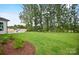 A spacious backyard with green grass and an outdoor kitchen at 14011 Camden Close Cir # 25, Huntersville, NC 28078