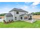 An exterior elevation of a home with backyard, including an outdoor kitchen at 14011 Camden Close Cir # 25, Huntersville, NC 28078
