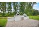 A backyard boasts an outdoor kitchen with a pizza oven and grill on a stone patio at 14011 Camden Close Cir # 25, Huntersville, NC 28078