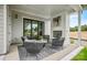 Inviting covered patio with an outdoor fireplace and comfortable seating. Perfect for entertaining or relaxing at 14011 Camden Close Cir # 25, Huntersville, NC 28078