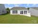 A verdant backyard with a concrete patio complements this lovely home at 1471 River Bend Blvd, Indian Land, SC 29707
