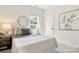 Bedroom with large window, ceiling fan, comfortable bed and stylish decor at 1471 River Bend Blvd, Indian Land, SC 29707