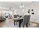 Bright dining room with hardwood floors, table with seating for four, and an elegant chandelier at 1471 River Bend Blvd, Indian Land, SC 29707