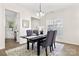 Chic dining room with modern chandelier, gray upholstered chairs, and neutral rug at 1471 River Bend Blvd, Indian Land, SC 29707