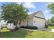 Charming home featuring a two-car garage, well-manicured lawn, and a mature, flowering tree in the front yard at 1471 River Bend Blvd, Indian Land, SC 29707