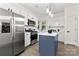 Modern kitchen features stainless steel appliances, white cabinets, and a stylish blue island at 1471 River Bend Blvd, Indian Land, SC 29707