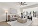 Cozy living room with ample natural light, featuring a comfortable sofa, coffee table and ceiling fan at 1471 River Bend Blvd, Indian Land, SC 29707