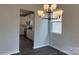 Elegant dining room features a modern chandelier and a view into the adjacent kitchen area at 152 Ella Claire Dr, York, SC 29745