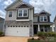 Charming two-story home with stone accents, a two-car garage, and beautifully manicured landscaping at 152 Ella Claire Dr, York, SC 29745