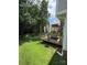 Inviting backyard deck features a canopy, black railings, and ample space for outdoor enjoyment, surrounded by lush greenery at 1902 Stonewyck Ave, Kannapolis, NC 28081