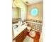 Cozy powder room with wallpaper, unique window, and decorative accents, perfect for guests' convenience at 1902 Stonewyck Ave, Kannapolis, NC 28081