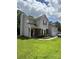 Beautiful two-story home with well-kept lawn, red front door, and attached garage on a sunny day at 1902 Stonewyck Ave, Kannapolis, NC 28081