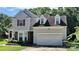 Charming two-story home with gray siding, red shutters, attached two car garage, and well-maintained landscaping at 1902 Stonewyck Ave, Kannapolis, NC 28081