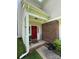 Charming covered front porch with brick accents and bright red door, creating a welcoming entrance at 1902 Stonewyck Ave, Kannapolis, NC 28081
