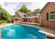 Beautiful backyard with a diving board, brickwork, covered patio, and well-maintained pool at 1933 Tara Trl, Lancaster, SC 29720
